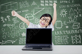 Kid celebrate her achievement with laptop in class