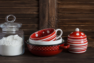 Kitchen still life. Glass jar with flour and vintage crockery -  mug, bowl, jar and pan