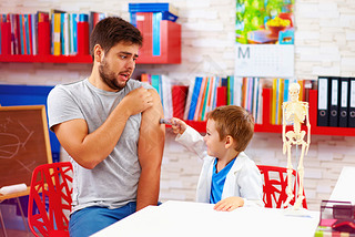 family playing in doctor and patient, father scared of injection