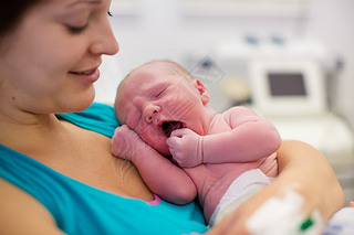 Young mother giving birth to a baby