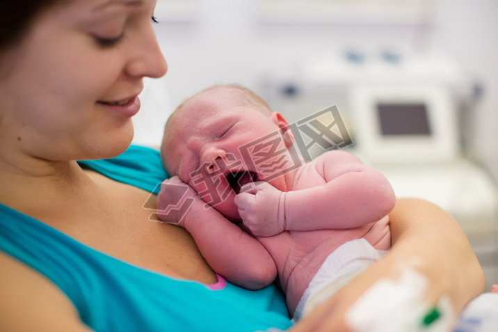 Young mother giving birth to a baby