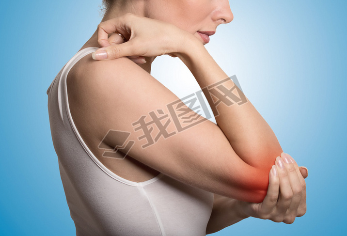 woman with painful elbow on blue background