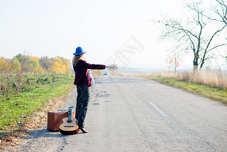 Young lonely woman and baby hitchhiking