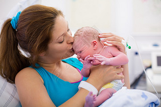 Young mother giving birth to a baby