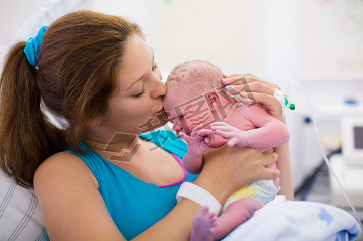 Young mother giving birth to a baby