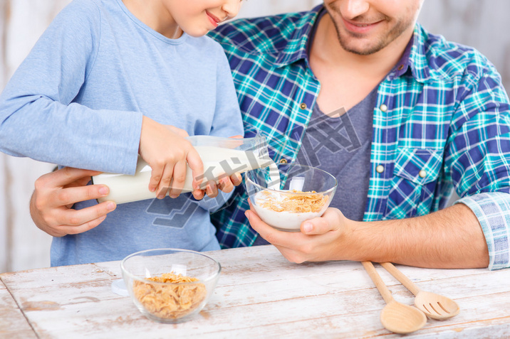 Positive father and daughter hing breakfast