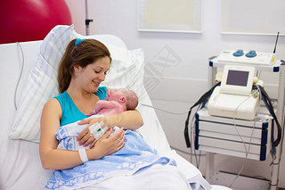 Young mother giving birth to a baby