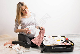 Woman packing baby clothes