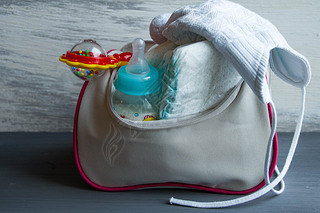 Womens handbag with items to care for the baby