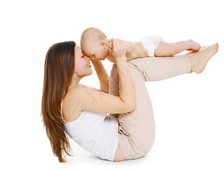 Young mother and baby are doing exercise and hing fun on a whi