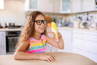 little girl with yellow wy parrot