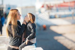 Mom and daughter spend time walking near the sea