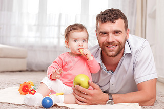 Father and little kid sitting on floor