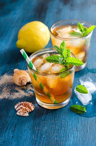 Fresh cold iced tea with mint, ice and lemons, refreshing drink