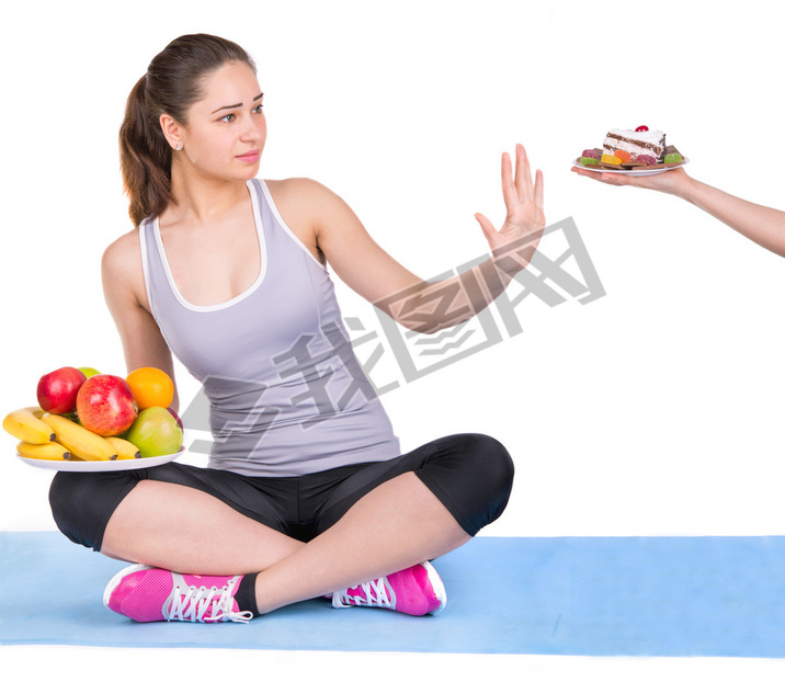 girl on a sports carpet chooses fruit instead of sweets