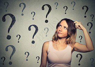 Thinking young woman with looking up at many questions marks