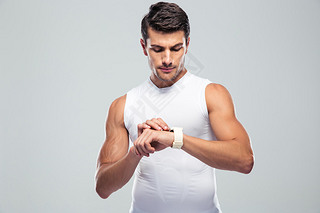 Handsome fitness man using art watch