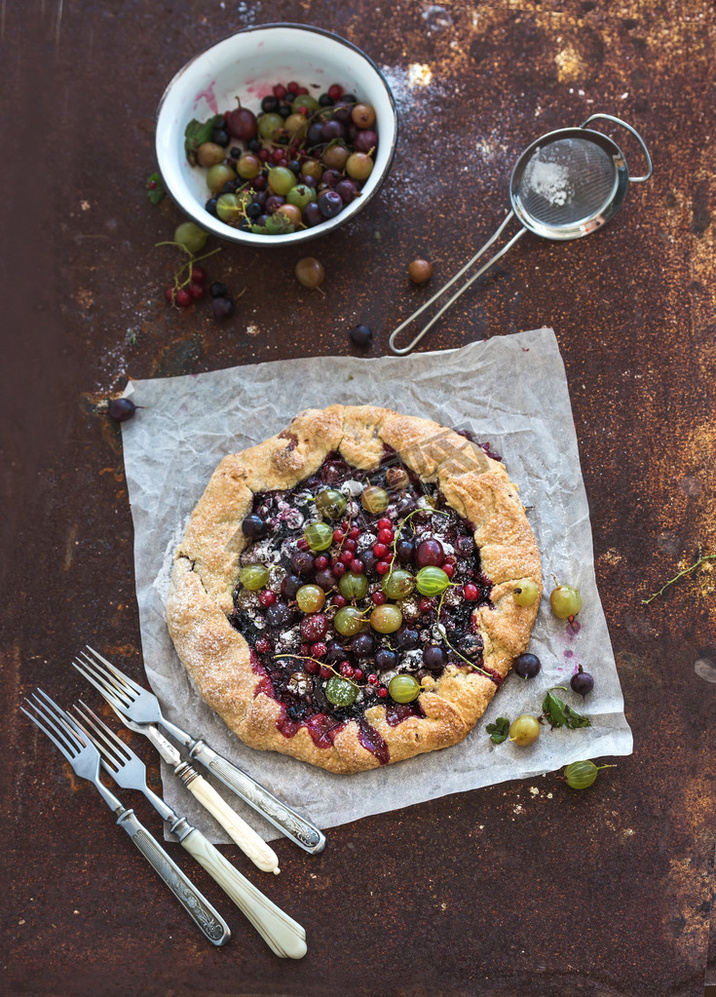 Summer crostata or galette pie with fresh garden berries and van