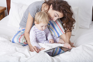 mother baby and tablet in bed