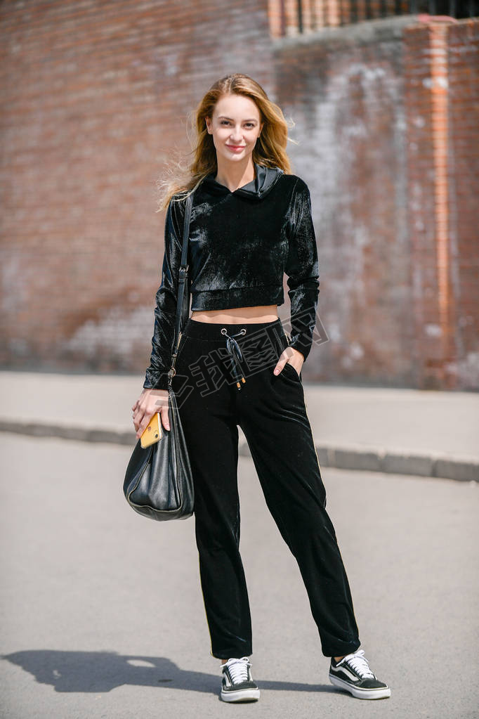 A trendy woman in fashionable outfit is pictured on the street during the China Fashion Week Fall/Wi