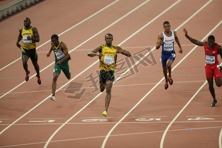 Usain Bolt of Jamaica, center, crosses the finish line to win the men's 200m final during the Beijin