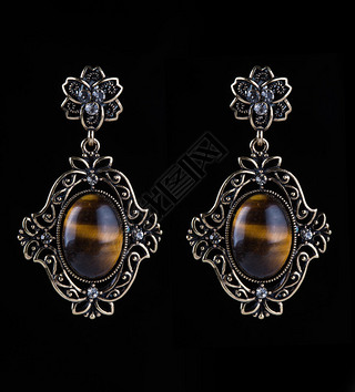 bronze earrings with jewels on the black