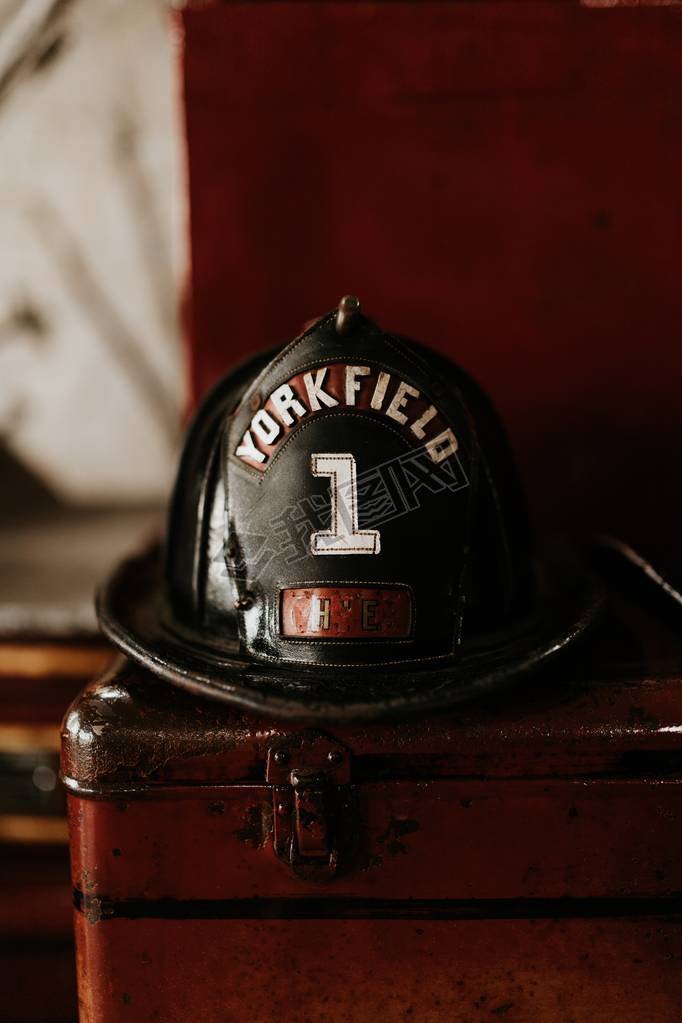 Vertical closeup shot of a firefighter helmet with Yorkfield and the number 1 written on it