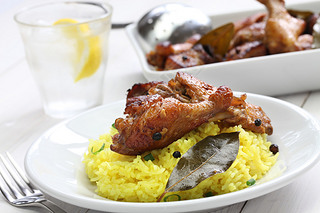 chicken and pork adobo over yellow rice, filipino food