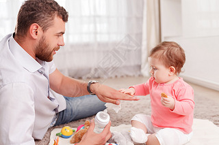 Nice father feeding his baby