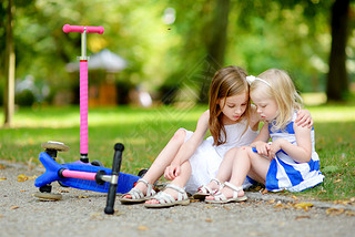 girl comforting her sister after she fell