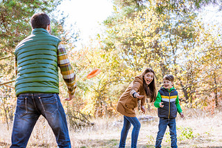 Happy family playing with frisbee