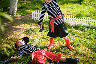 children play pirates at backyard