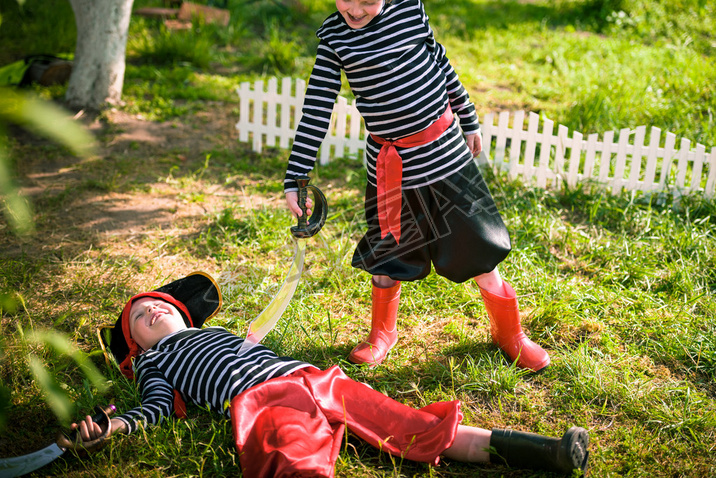 children play pirates at backyard