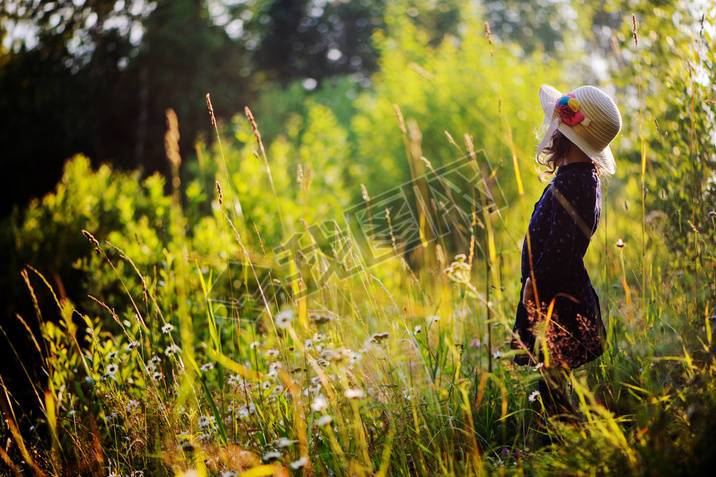 dreamy child girl on summer walk on riverside. Cozy rural scene. Outdoor activities on summer vacati