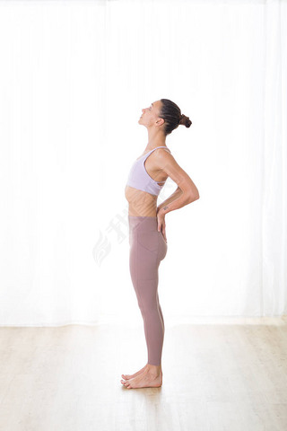 Portrait of gorgeous active sporty young woman practicing yoga in studio. Beautiful girl practice Ar