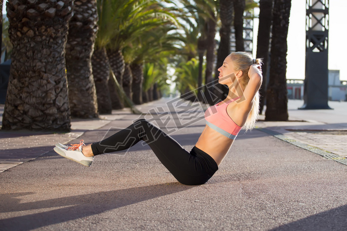 Sportswoman doing physical exercise