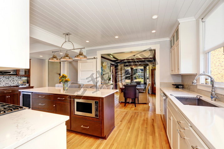 White interior of kitchen room with large kitchen island.