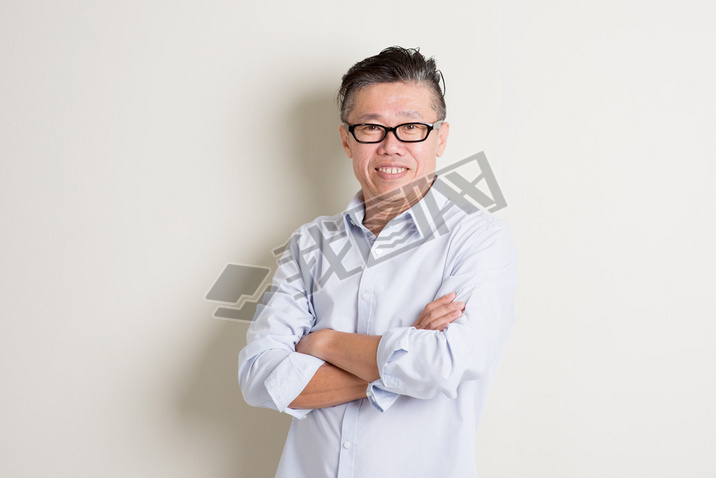 Portrait of mature Asian male arms crossed