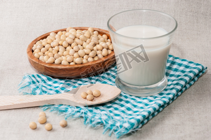 Glass of milk and bowl with soy
