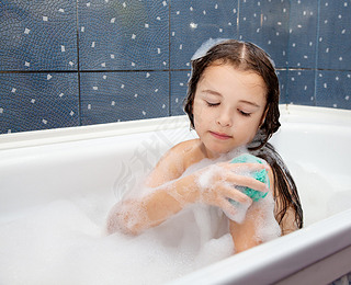 girl washes her hand sitting in the bath