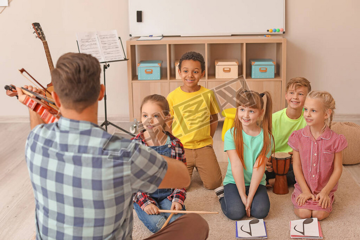 Teacher giving music lessons at school