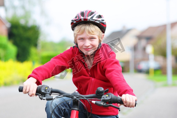 School boy riding his bike