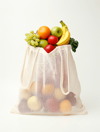 白色网格布袋里面的各种水果创意产品素材高清摄影图