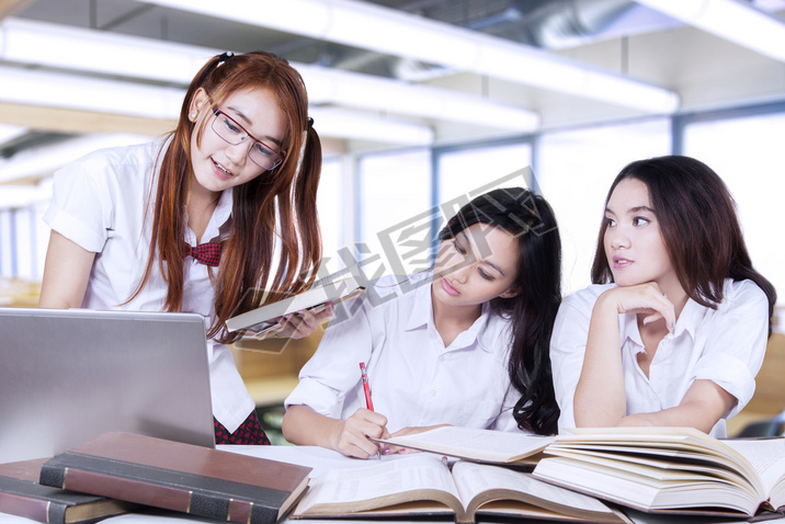 Three lovely female learners studying in class