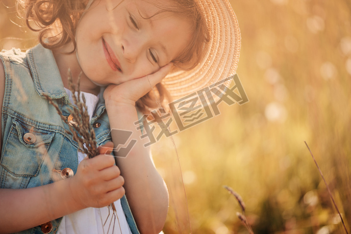 happy child on summer field, spending vacation outdoor, warm rural scene