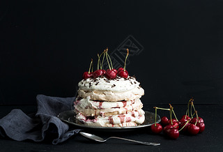 Plova cake with fresh cherry, cheese cream and chocolate chips in vintage silver plate over dark g