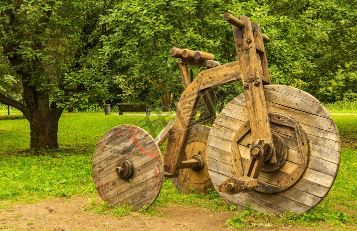 Wooden sculpture bike with three wheels