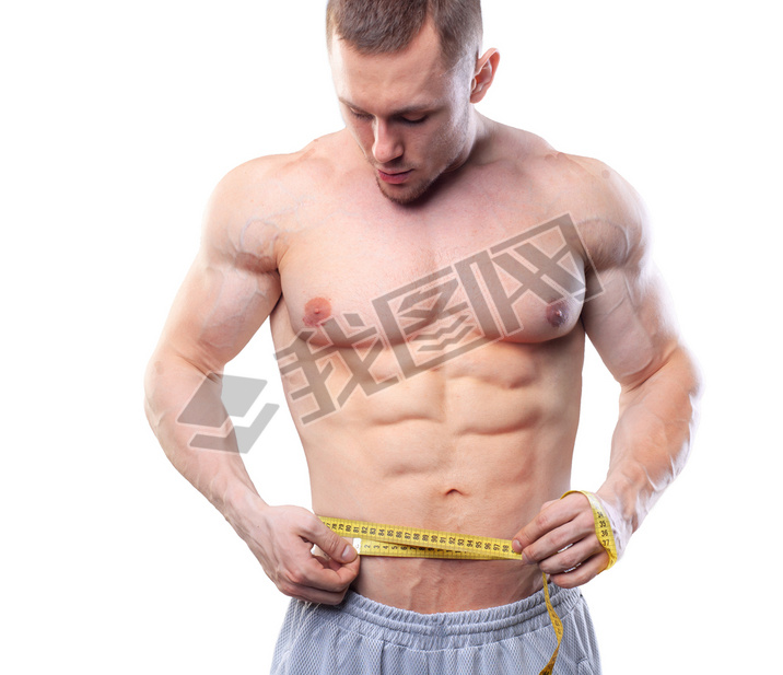 Image of muscular man measure his waist with measuring tape in centimeters. Shot isolated on white b