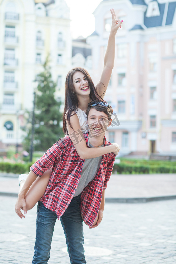 Happy young couple laughing in the city. Love Story series.