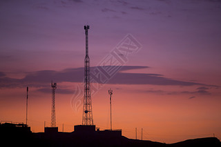 Communication towers on orange purple sky background, Peru